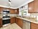 Spacious kitchen with stainless steel appliances, countertops, cabinets, and a window at 812 Madison St, Frankton, IN 46044