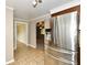 View of the stainless steel refrigerator showcasing the opening to the hallway and living room at 812 Madison St, Frankton, IN 46044