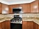 Close up of kitchen with stainless steel appliances, countertops, backsplash, and cabinets at 812 Madison St, Frankton, IN 46044