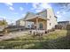 Large, lush backyard featuring a covered patio, gravel firepit, and manicured landscaping at 8352 Alcona Dr, Indianapolis, IN 46237