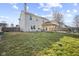 Large backyard with a well maintained lawn, covered patio, privacy fence, and a fire pit at 8352 Alcona Dr, Indianapolis, IN 46237