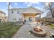 Inviting backyard with a covered patio, stone fire pit, and plenty of room for entertaining at 8352 Alcona Dr, Indianapolis, IN 46237