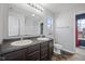 Well-lit bathroom with a double sink vanity, large mirror and updated fixtures at 8352 Alcona Dr, Indianapolis, IN 46237