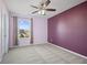 A serene bedroom features a large window offering picturesque neighborhood views at 8352 Alcona Dr, Indianapolis, IN 46237