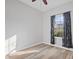 Clean bedroom with modern ceiling fan, neutral wall color, wood laminate flooring, and a window with nice drapes at 8352 Alcona Dr, Indianapolis, IN 46237