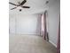 Neutral bedroom showcasing neutral walls, carpet, ceiling fan and a white door at 8352 Alcona Dr, Indianapolis, IN 46237