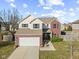 Charming two-story home with brick accents, a well-maintained lawn, and attached two car garage at 8352 Alcona Dr, Indianapolis, IN 46237