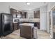 Well-equipped kitchen with a center island, dark appliances, and neutral countertops at 8352 Alcona Dr, Indianapolis, IN 46237