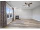 Cozy living room with a fireplace, large windows, and neutral-toned walls at 8352 Alcona Dr, Indianapolis, IN 46237