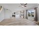 Living room and open kitchen area with light-colored floors and large windows at 8352 Alcona Dr, Indianapolis, IN 46237