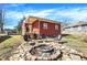 Backyard featuring a fire pit, patio space, and a red home with a porch at 8657 S Nash Dr, Nineveh, IN 46164