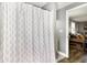 This bathroom shows a decorative shower curtain separating the room and a view into the home's living space at 8657 S Nash Dr, Nineveh, IN 46164