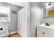 Bright bathroom featuring neutral walls, a window, and a vanity with modern black hardware at 8657 S Nash Dr, Nineveh, IN 46164