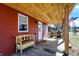 Covered porch featuring rustic wood and a decorative bench, creating a welcoming outdoor space at 8657 S Nash Dr, Nineveh, IN 46164