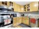 Well-lit kitchen featuring stainless steel appliances and warm wood cabinetry at 8657 S Nash Dr, Nineveh, IN 46164