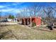 Exterior yard view of red home with covered porch, an American flag, and some trees at 8657 S Nash Dr, Nineveh, IN 46164