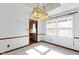 Bright dining room with modern lighting and a large window, next to the kitchen at 8831 Lincolncreek Cir, Indianapolis, IN 46234