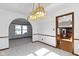 Dining room featuring an elegant chandelier and an open archway to other rooms at 8831 Lincolncreek Cir, Indianapolis, IN 46234