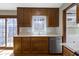 Spacious kitchen featuring a large window, wood cabinets, and stainless steel dishwasher at 8831 Lincolncreek Cir, Indianapolis, IN 46234