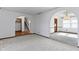 Spacious living room with arched doorways and neutral carpet flooring throughout the main level at 8831 Lincolncreek Cir, Indianapolis, IN 46234