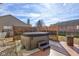 Backyard featuring a hot tub with a privacy screen, surrounded by stone and patio area at 917 Claiborne Ln, Lebanon, IN 46052