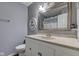 Bathroom with white vanity, neutral countertop, decorative mirror and gray walls at 917 Claiborne Ln, Lebanon, IN 46052