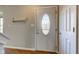 Entryway featuring a coat rack, wood laminate flooring, and a decorative front door window at 917 Claiborne Ln, Lebanon, IN 46052
