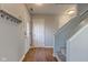 Entryway featuring a coat rack, wood laminate flooring, and staircase at 917 Claiborne Ln, Lebanon, IN 46052