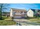 Charming two-story home with a two-car garage, a basketball hoop and well-manicured front yard at 917 Claiborne Ln, Lebanon, IN 46052