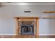 Close-up of the fireplace with a stone surround and wooden mantel at 917 Claiborne Ln, Lebanon, IN 46052