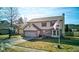 Two story home with a two car garage, dormer, and manicured lawn at 917 Claiborne Ln, Lebanon, IN 46052