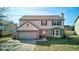 Two story home with a two car garage, brick entryway and dormer at 917 Claiborne Ln, Lebanon, IN 46052
