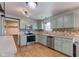 Updated kitchen featuring stainless steel appliances, decorative backsplash, and hardwood flooring at 917 Claiborne Ln, Lebanon, IN 46052