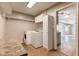 Laundry room with washer, dryer, storage cabinets, and overhead shelving at 917 Claiborne Ln, Lebanon, IN 46052