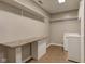 Functional laundry room with built-in shelving and countertop workspace at 917 Claiborne Ln, Lebanon, IN 46052