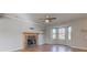 Bright living room featuring a fireplace, bay window and wood laminate flooring at 917 Claiborne Ln, Lebanon, IN 46052