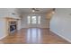Bright living room featuring a fireplace, bay window and wood laminate flooring at 917 Claiborne Ln, Lebanon, IN 46052