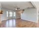 Open living room featuring a fireplace, bay window, coat rack and wood laminate flooring at 917 Claiborne Ln, Lebanon, IN 46052