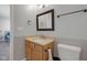 Bathroom featuring a framed mirror, vanity with storage, and convenient toilet placement at 9730 Prairie Smoke Dr, Noblesville, IN 46060