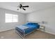 A carpeted bedroom featuring a ceiling fan and a bed with a blue comforter at 9730 Prairie Smoke Dr, Noblesville, IN 46060