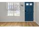 Inviting entryway with wood floors, a window with blinds, and a stylish blue front door at 9730 Prairie Smoke Dr, Noblesville, IN 46060