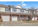 Charming two-story townhouse features a brick facade and a one-car garage, nestled under a partly cloudy sky at 9730 Prairie Smoke Dr, Noblesville, IN 46060