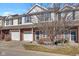 Charming two-story townhouse features a brick facade and a one-car garage, nestled under a partly cloudy sky at 9730 Prairie Smoke Dr, Noblesville, IN 46060