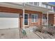 Charming two-story townhouse features a brick facade and a one-car garage, nestled under a partly cloudy sky at 9730 Prairie Smoke Dr, Noblesville, IN 46060