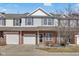 Charming two-story townhouse features a brick facade and a one-car garage, nestled under a partly cloudy sky at 9730 Prairie Smoke Dr, Noblesville, IN 46060