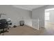 Open hallway features neutral carpet, gray walls, and white trim at 9730 Prairie Smoke Dr, Noblesville, IN 46060