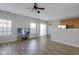 Bright living room featuring wood floors, a ceiling fan, and natural light at 9730 Prairie Smoke Dr, Noblesville, IN 46060
