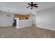 Open-concept living room with wood floors and view into kitchen at 9730 Prairie Smoke Dr, Noblesville, IN 46060