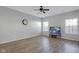 Bright living room with wood floors, neutral paint, and a ceiling fan, creating a cozy atmosphere at 9730 Prairie Smoke Dr, Noblesville, IN 46060