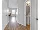 Hallway view with a glimpse of a modern powder room featuring a pedestal sink and neutral decor at 9730 Prairie Smoke Dr, Noblesville, IN 46060